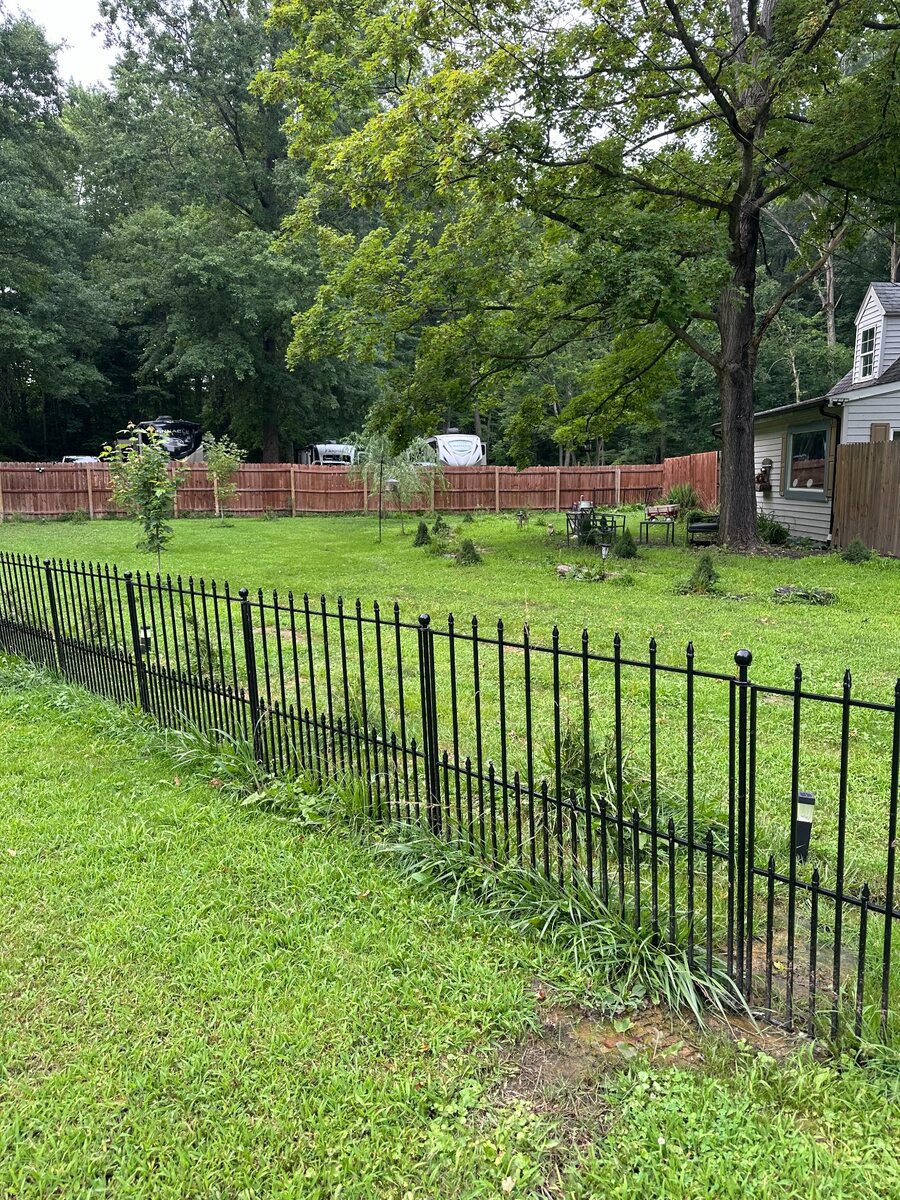 Green fenced grounds beside the Prairie House RV spaces